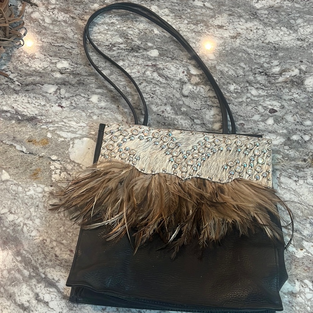 Leather purse with feathers and crystals
